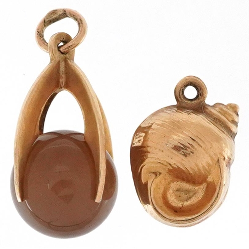 2532 - Two 9ct gold charms comprising an agate sphere and a snail shell, the largest 1.9cm high, total 2.6g