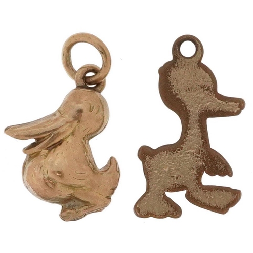 2503 - Two yellow metal charms in the form of a comical duck and pelican, the largest 1.6cm high, total 1.6... 