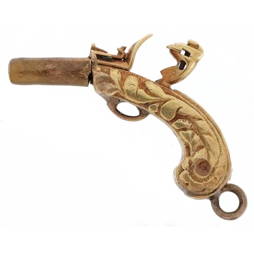 2501 - Unmarked gold and yellow metal charm in the form of an antique pistol, 2.3cm in length, 3.1g