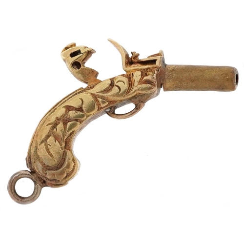 2501 - Unmarked gold and yellow metal charm in the form of an antique pistol, 2.3cm in length, 3.1g