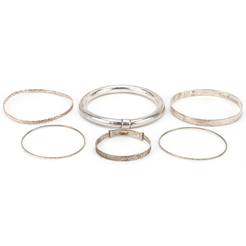 2704 - Six silver and white metal bangles including a christening bangle, the largest 8cm in diameter, tota... 