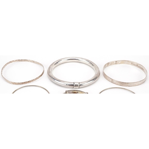 2704 - Six silver and white metal bangles including a christening bangle, the largest 8cm in diameter, tota... 