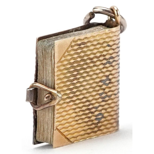 2523 - 9ct gold charm in the form of a book with London postcards, 1.5cm high, 2.3g