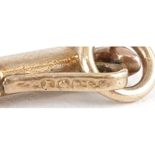 2575 - Two 9ct gold charms in the form of a lucky horseshoe and golf clubs with caddy, the largest 1.5cm hi... 