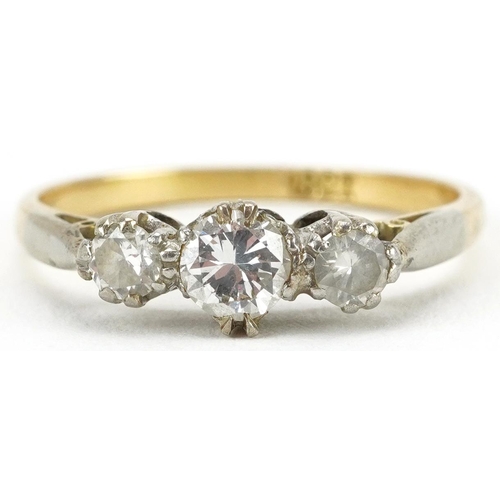 2212 - 18ct gold diamond three stone ring, the largest diamond approximately 0.22 carat, size O, 2.7g