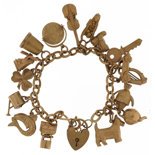 9ct gold charm bracelet with a collection of mostly 9ct gold charms including Good Luck spinner, windmill, wishing well and watering can, 16cm in length, 21.5g