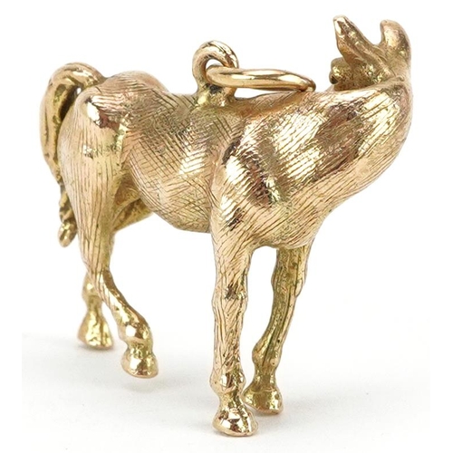 2110 - 9ct gold charm in the form of a standing horse, 2.4cm in length, 7.8g