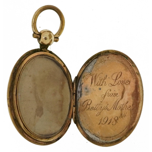 2218 - Yellow Metal engine turned oval locket, 3.9cm high,