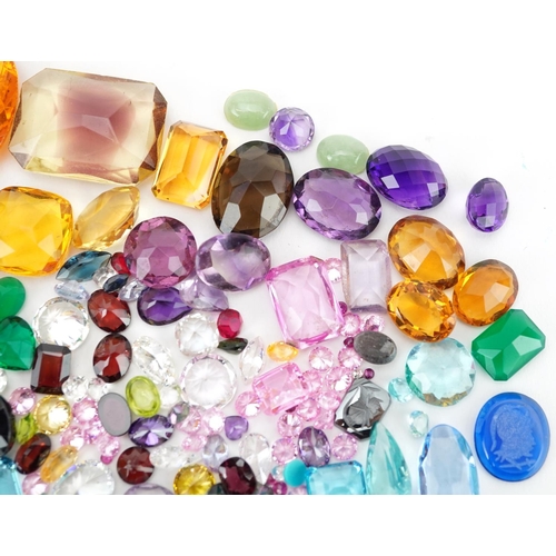 2190 - Loose gemstones and intaglios including blue topaz, citrine, amethyst, garnet and sapphires, the lar... 