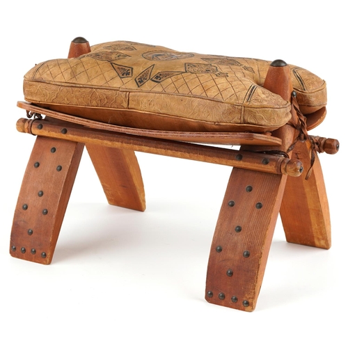 1045 - Vintage hardwood camel stool with leather upholstered cushion tooled with foliate motifs and a camel... 