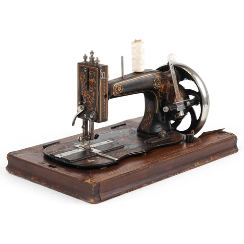 183 - Victorian cast iron sewing machine with case, the sewing machine numbered 2004356, the case 40.5cm w... 