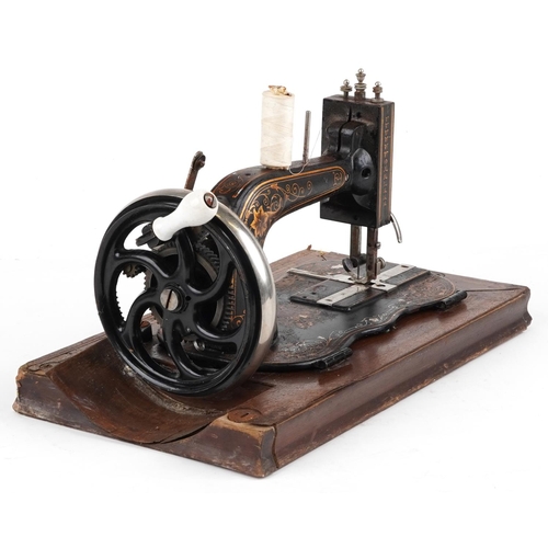 183 - Victorian cast iron sewing machine with case, the sewing machine numbered 2004356, the case 40.5cm w... 