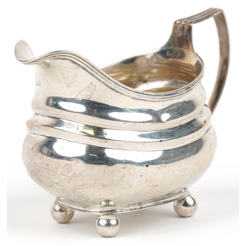 231 - George III silver cream jug with four ball feet, indistinct maker's mark London 1819, 13cm in length... 