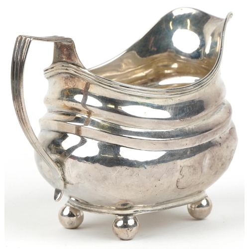 231 - George III silver cream jug with four ball feet, indistinct maker's mark London 1819, 13cm in length... 