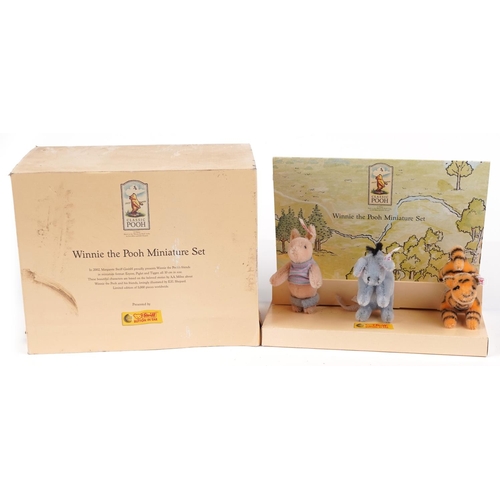 1609 - Steiff Winnie the Pooh miniature set with box arranged in a display stand, with certificate comprisi... 