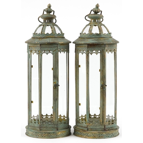 1406 - Pair of bronzed hanging lanterns with glass panels, 59cm high