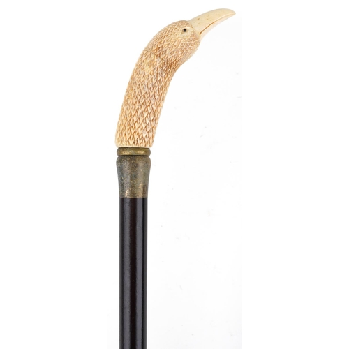 514 - Ebonised walking stick with carved bone handle in the form of an eagle head, 90cm in length