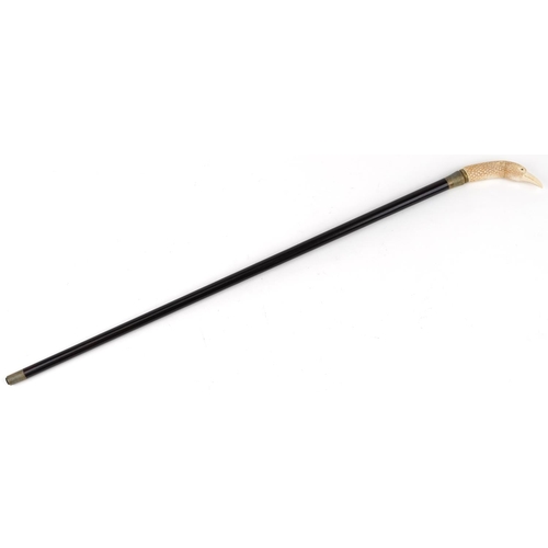 514 - Ebonised walking stick with carved bone handle in the form of an eagle head, 90cm in length