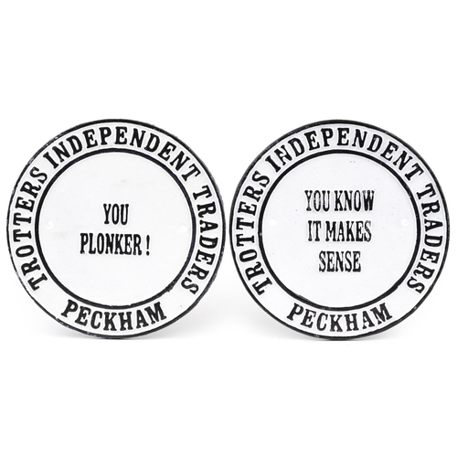 1465 - Pair of painted cast iron Trotters Independent Traders advertising plaques, 24cm in diameter