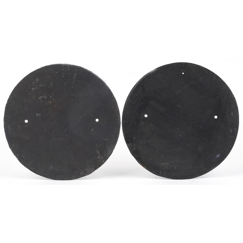 1465 - Pair of painted cast iron Trotters Independent Traders advertising plaques, 24cm in diameter