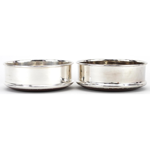 1320 - Pair of silver plated and oak circular wine coasters, 12.5cm in diameter