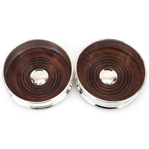 1320 - Pair of silver plated and oak circular wine coasters, 12.5cm in diameter