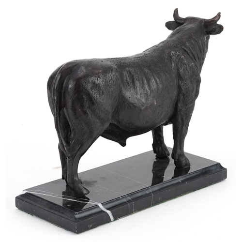 495 - Patinated bronze study of a bull raised on a black marble base, 26cm in length