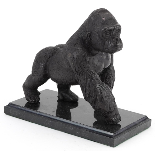 494 - Patinated study of a gorilla raised on a black marble base, 20cm in length