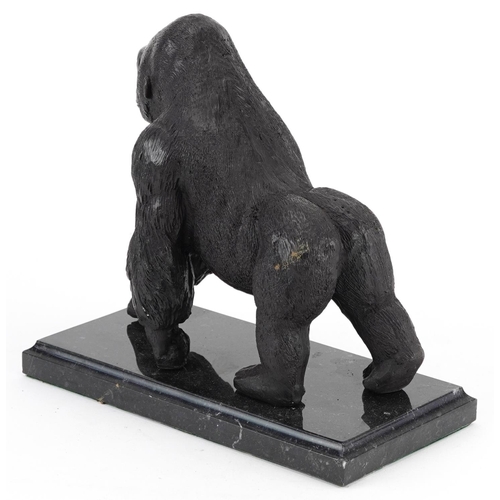 494 - Patinated study of a gorilla raised on a black marble base, 20cm in length