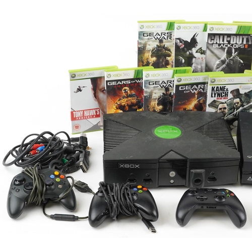 1619 - Two Microsoft Xbox games consoles with controllers and a collection of games