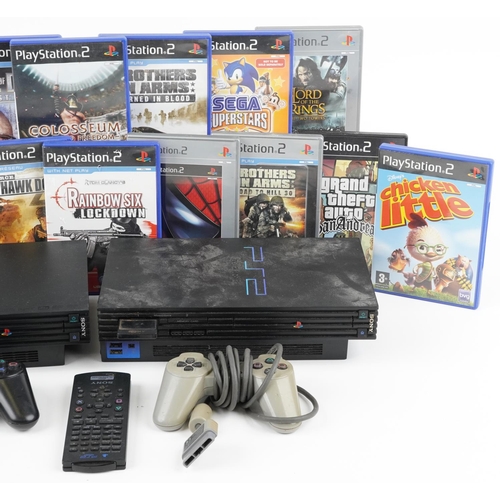 1626 - Two Sony PlayStation 2 games consoles with controllers and a collection of games