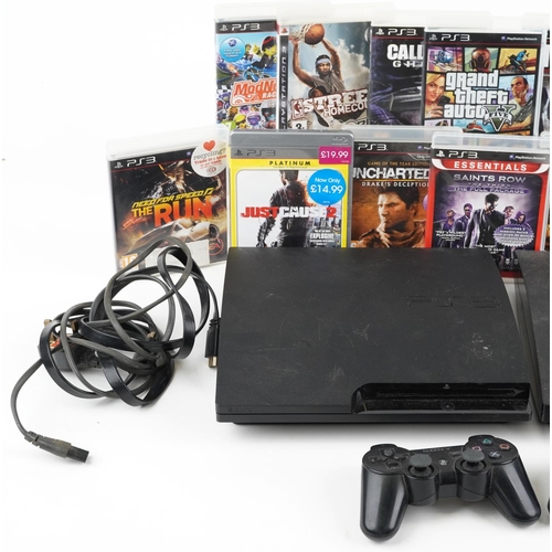 1627 - Two Sony PlayStation 3 games consoles with controllers and a collection of games