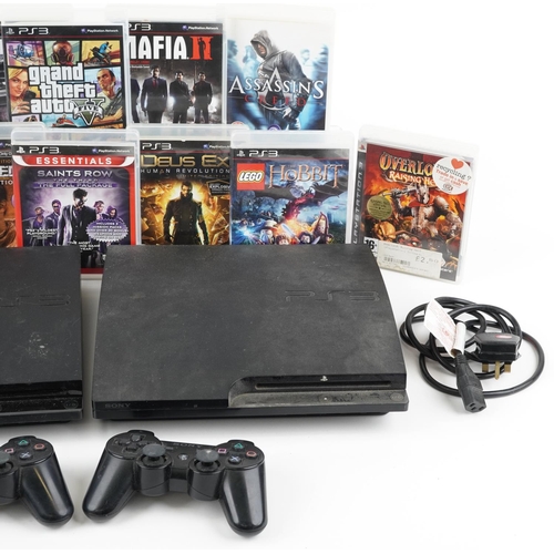 1627 - Two Sony PlayStation 3 games consoles with controllers and a collection of games