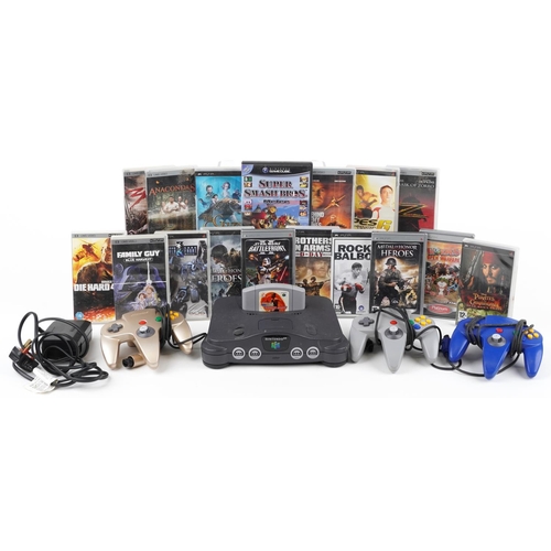 1629 - Nintendo 64 games console with controllers and a collection of Sony PSP games and movies