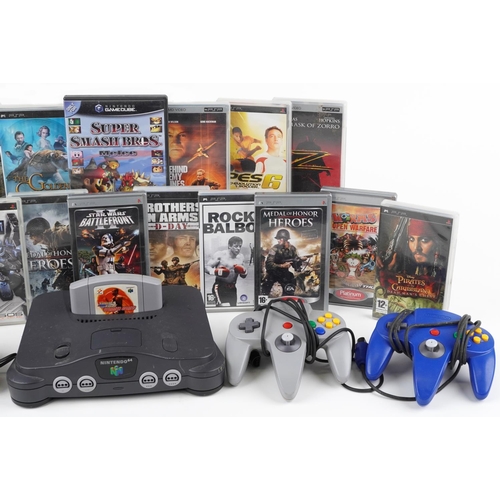 1629 - Nintendo 64 games console with controllers and a collection of Sony PSP games and movies