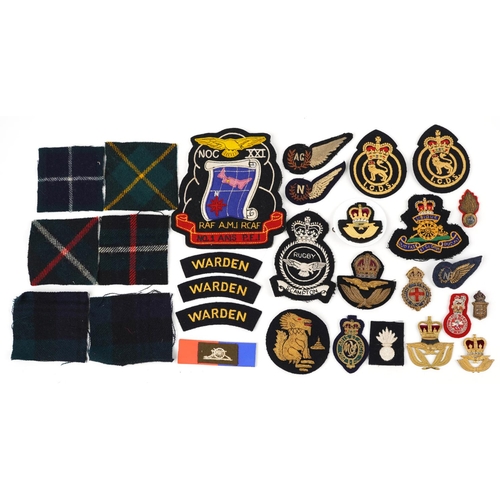 634 - Military interest cloth badges and shoulder titles including Air Gunner and Warden