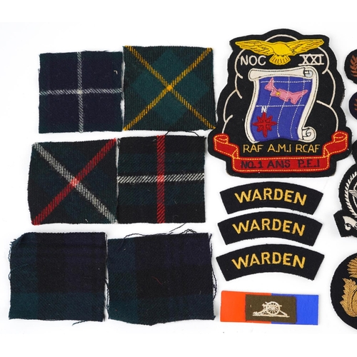 634 - Military interest cloth badges and shoulder titles including Air Gunner and Warden