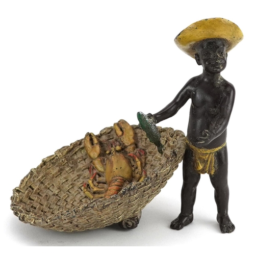 143 - Austrian style cold painted bronze model of a boy holding a fish beside a basket with lobster, 11cm ... 