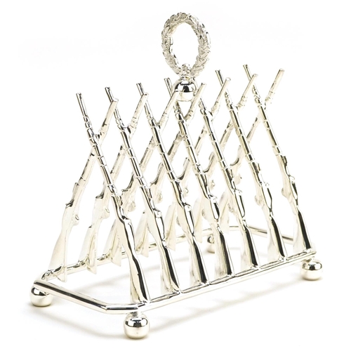 1336 - Military interest silver plated six slice toast rack in the form of rifles, 19.5cm wide