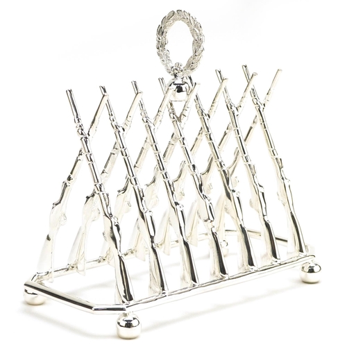 1336 - Military interest silver plated six slice toast rack in the form of rifles, 19.5cm wide