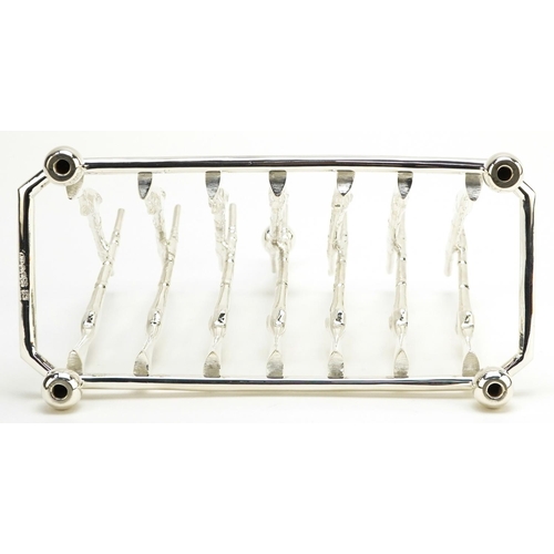 1336 - Military interest silver plated six slice toast rack in the form of rifles, 19.5cm wide