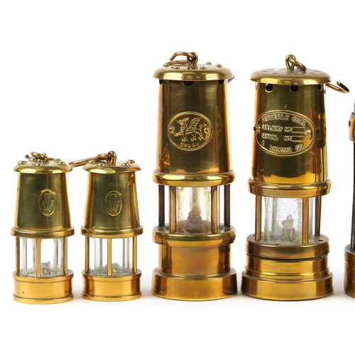 187 - Ten miner's lamps including Thomas & Williams type no 2, various plaques, the largest 26cm high