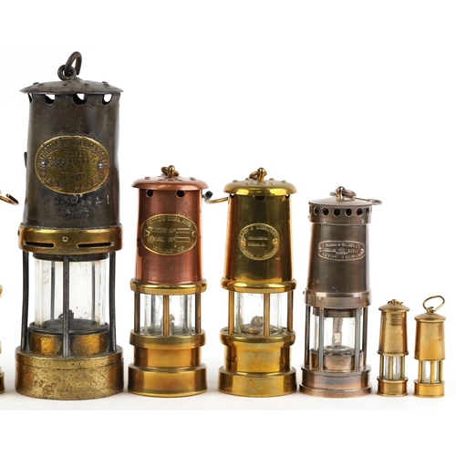 187 - Ten miner's lamps including Thomas & Williams type no 2, various plaques, the largest 26cm high