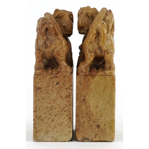 1322 - Pair of Chinese soapstone seals, each carved with a mythical animal, each 12.5cm high