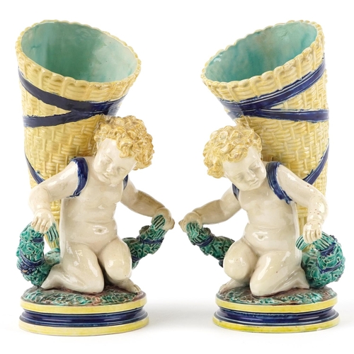 125 - Pair of 19th century European Maiolica vases in the form of Putti carrying cornucopia, each with imp... 