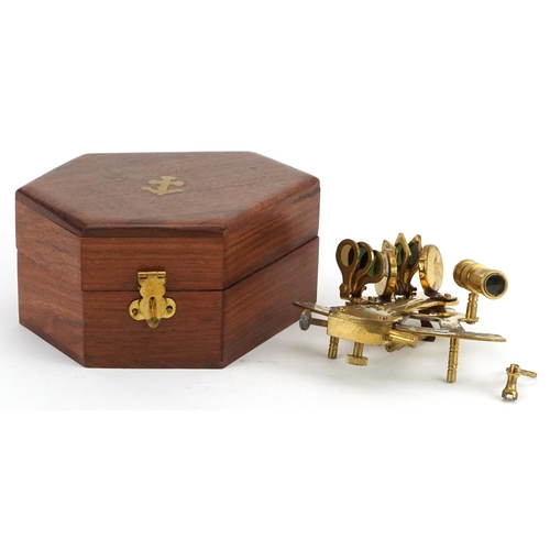 1331 - Shipping interest brass sextant housed in a hardwood case, the sextant 13cm in length