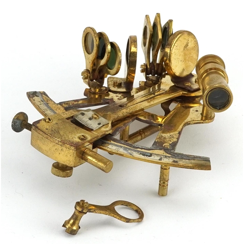 1331 - Shipping interest brass sextant housed in a hardwood case, the sextant 13cm in length