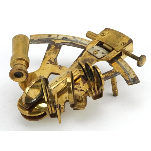 1331 - Shipping interest brass sextant housed in a hardwood case, the sextant 13cm in length