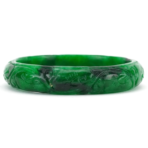 2220 - Chinese green jade bangle carved with foliage, 7cm in diameter, 47.0g