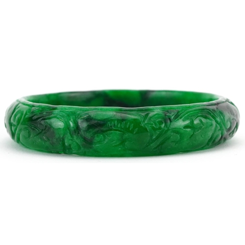 2220 - Chinese green jade bangle carved with foliage, 7cm in diameter, 47.0g